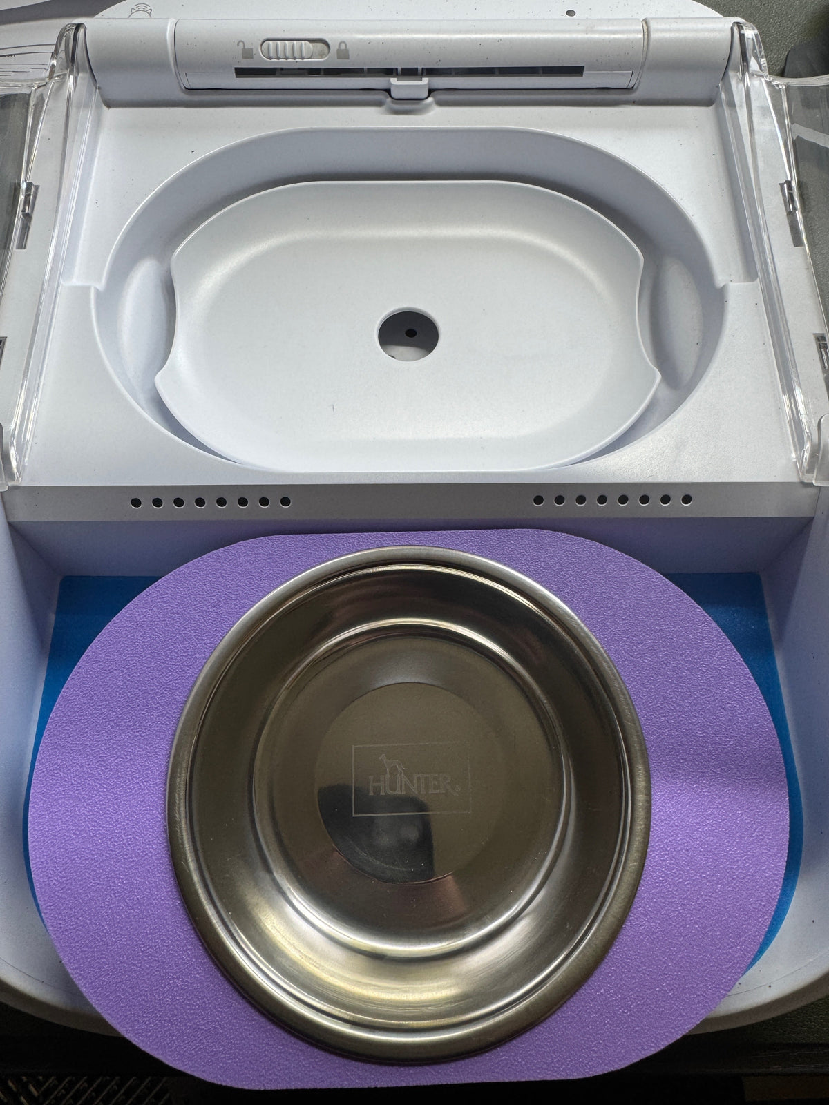 Purple single-bowl adaptor for SureFeed Connect with a bowl, beside the feeder compartment